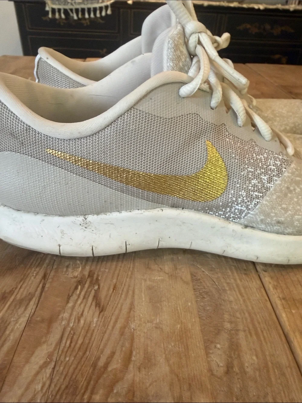 Nike Women's Light Gray Sneakers with Gold Swoosh